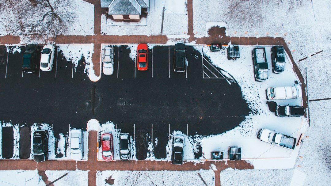 Overhead view of cars parked beside snowy sidewalks
