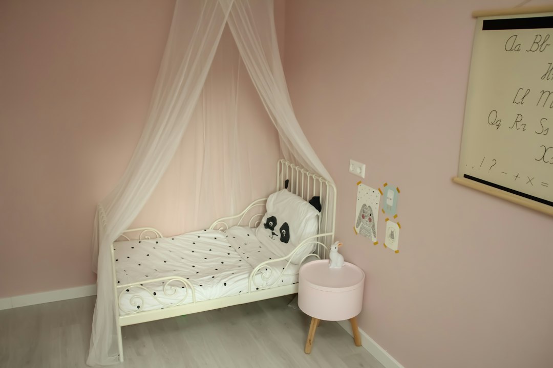 Child's bed beneath a hanging fabric canopy