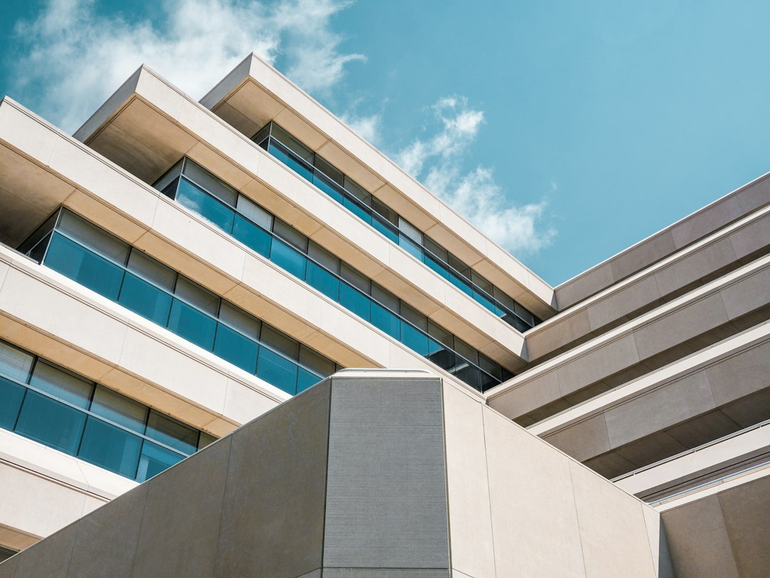 Stepped levels of a modern building with wide bands of glass windows.