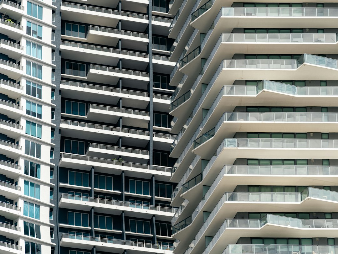 Stacked balconies across adjacent modern high-rise buildings.