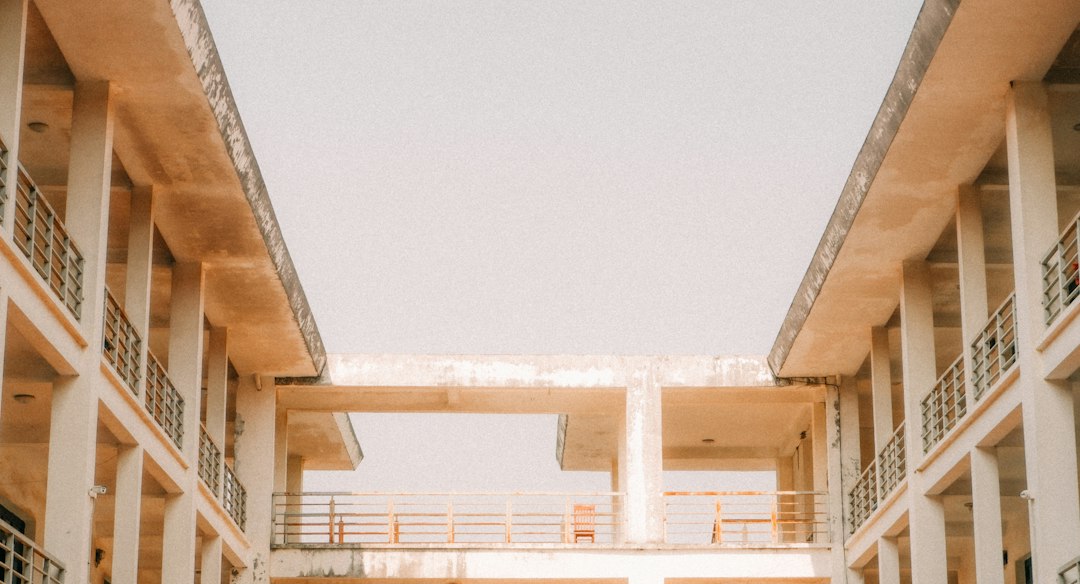 An open courtyard surrounded by two levels of concrete walkways.