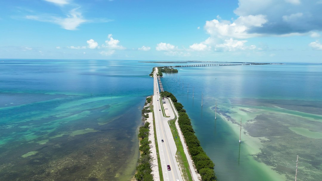 Aerial view of a coastal highway crossing turquoise water.