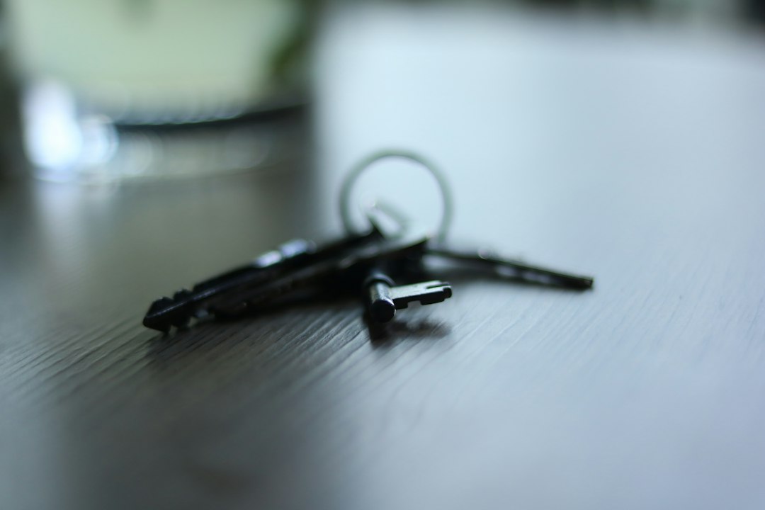 A set of keys resting on a dark wooden table