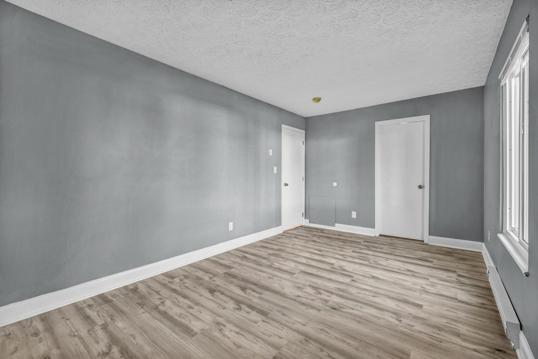 Empty room with gray walls and wood-look flooring