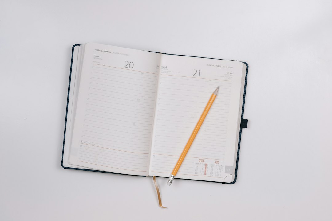 Open lined notebook with a yellow pencil