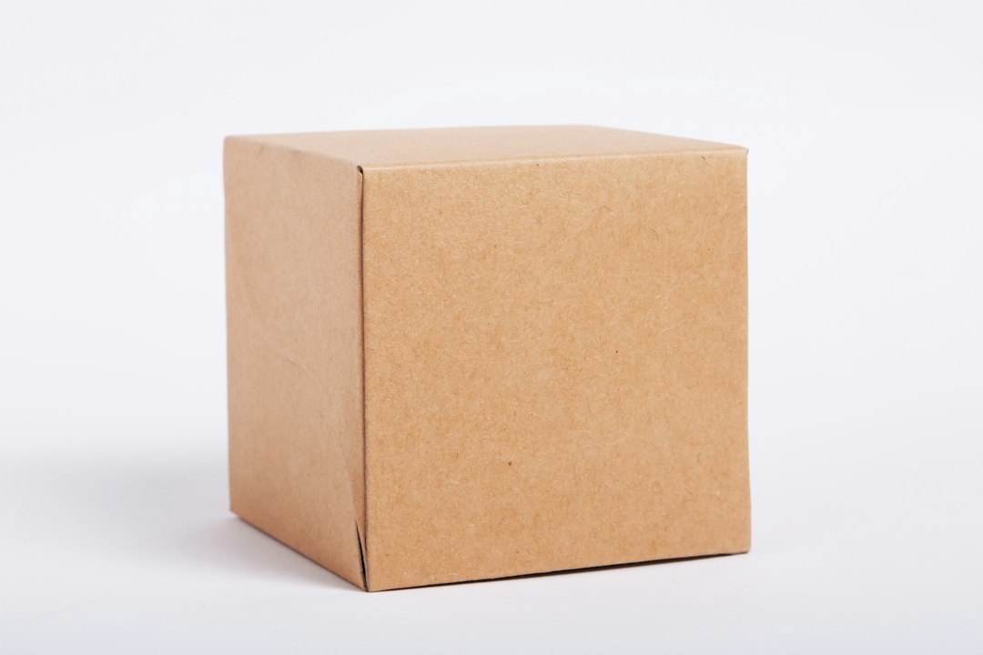 A sealed plain cardboard box against a light background.