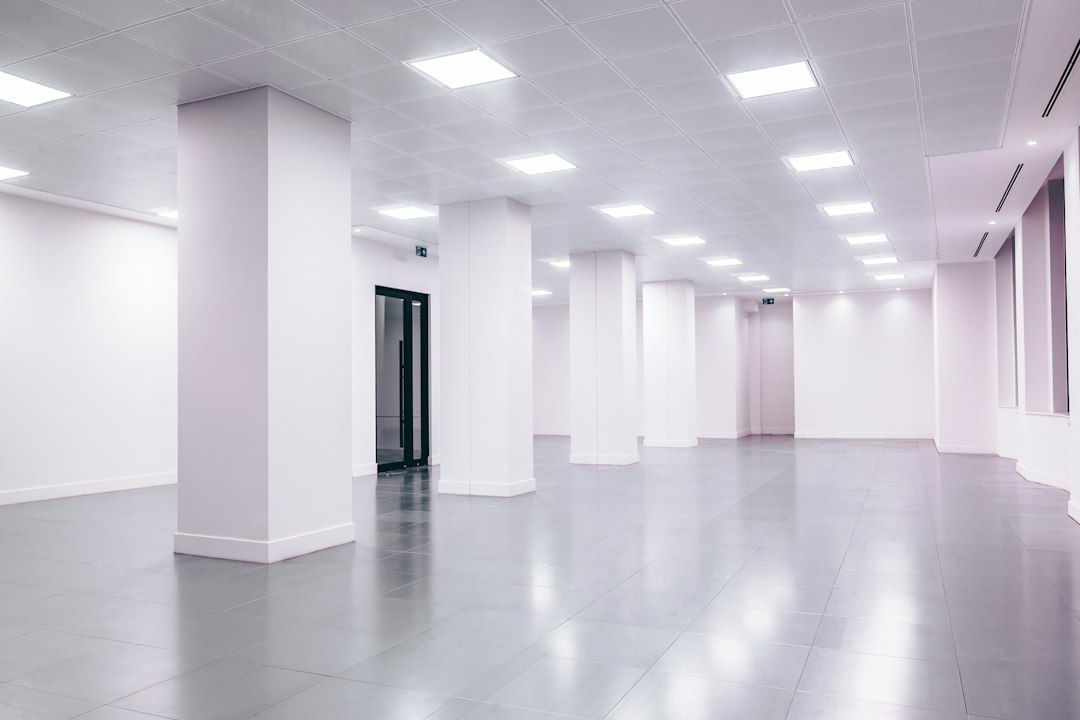 Large vacant office interior with bright ceiling lights