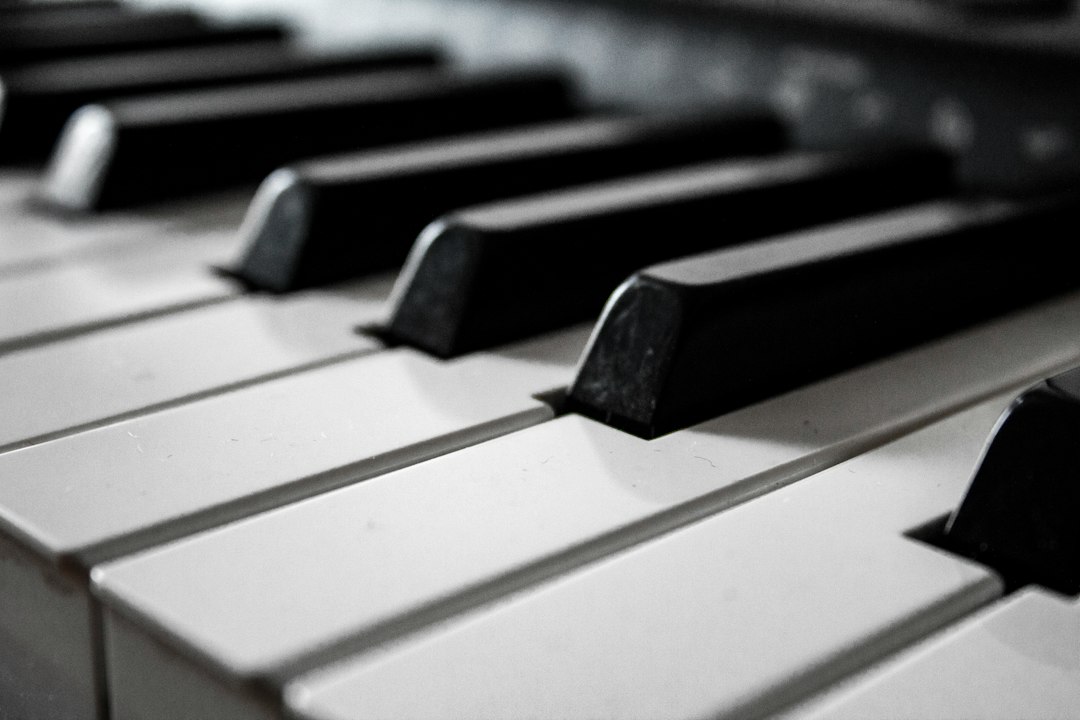 Black-and-white close-up of a piano keyboard.