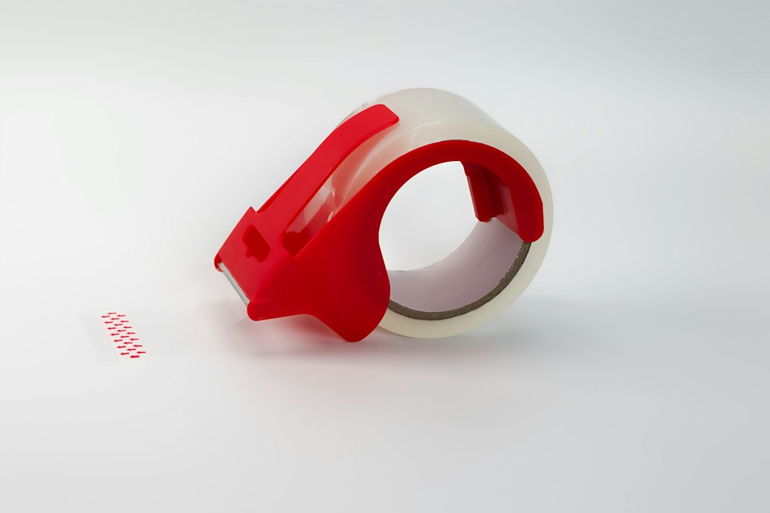 Clear tape in a red plastic dispenser
