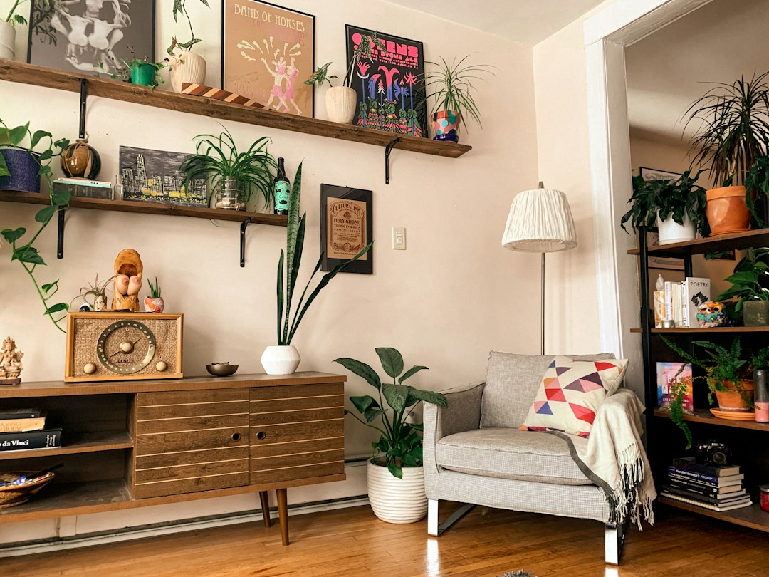 Armchair, sideboard and houseplants in a furnished living room